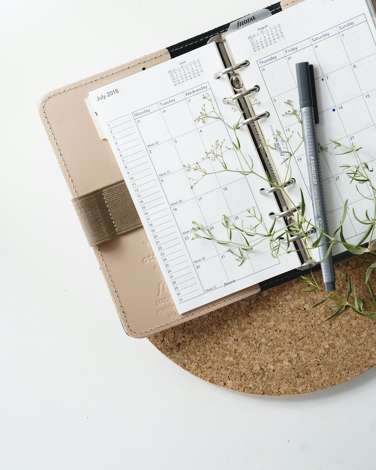 A planner and pen on a desk