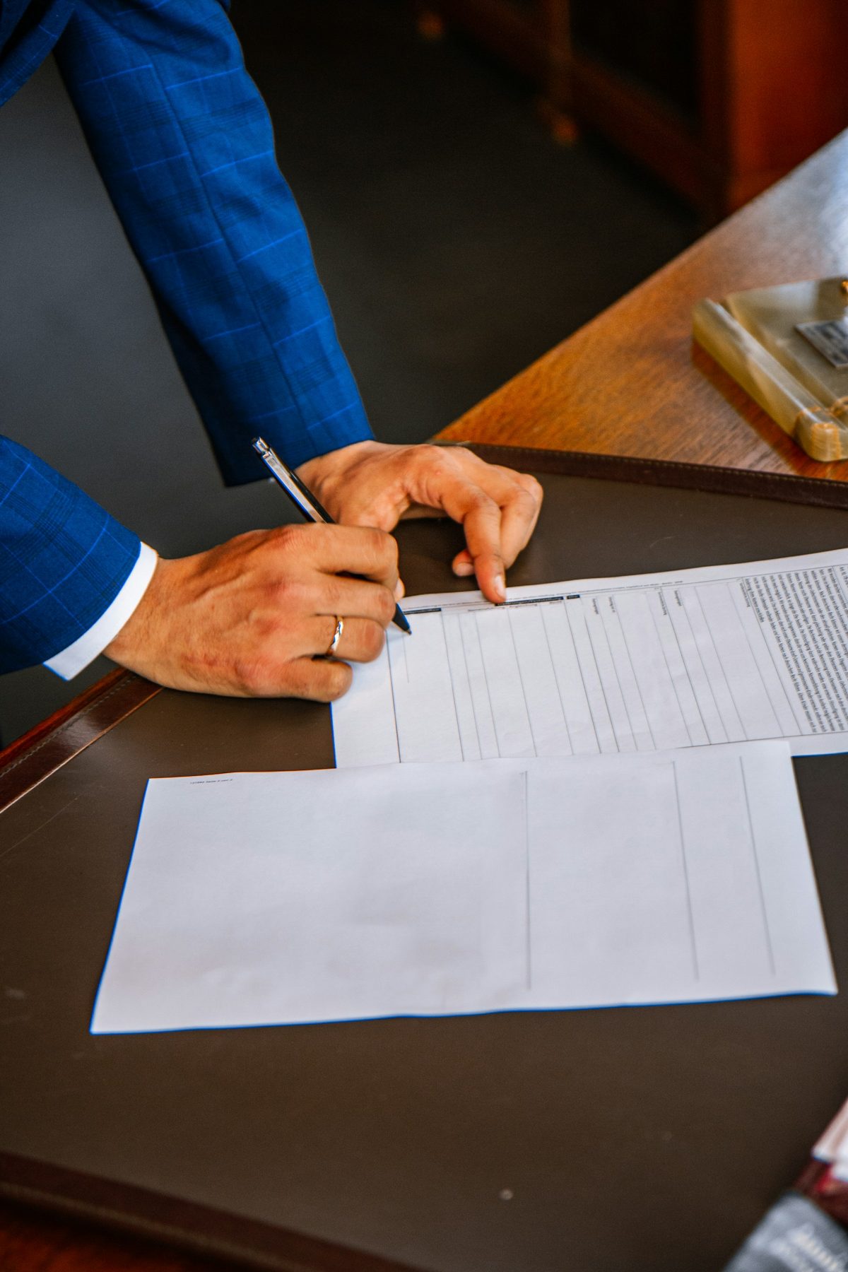 A person filling out forms at a desk